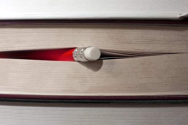 Pencil poking out from a book