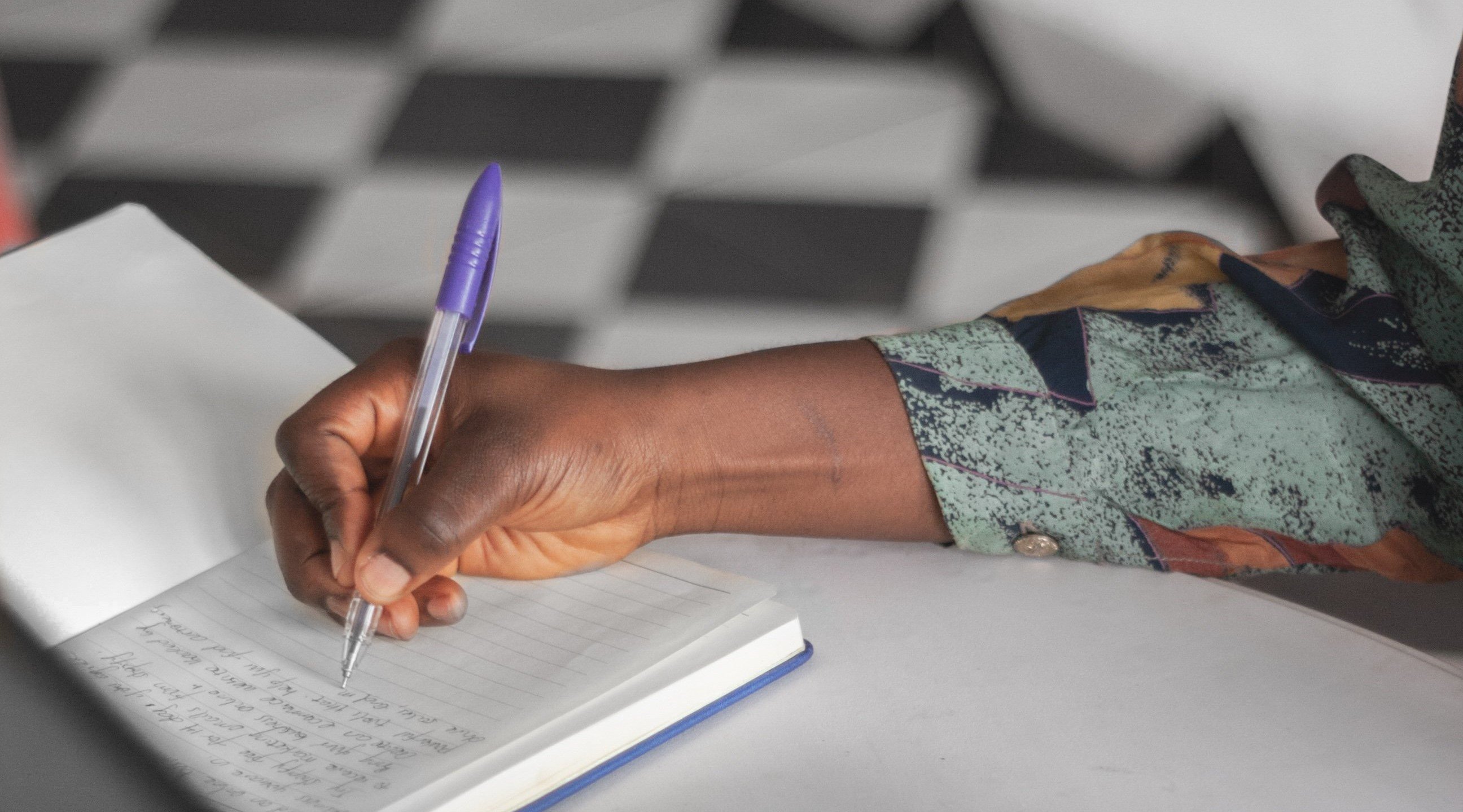 Blog_Lockdown_OneYearOn_hand-writes-in-a-notebook-by-a-laptop-and-cellphone_PhotoCredit_Joshua Bamidele_Burst_Shopify_Banner